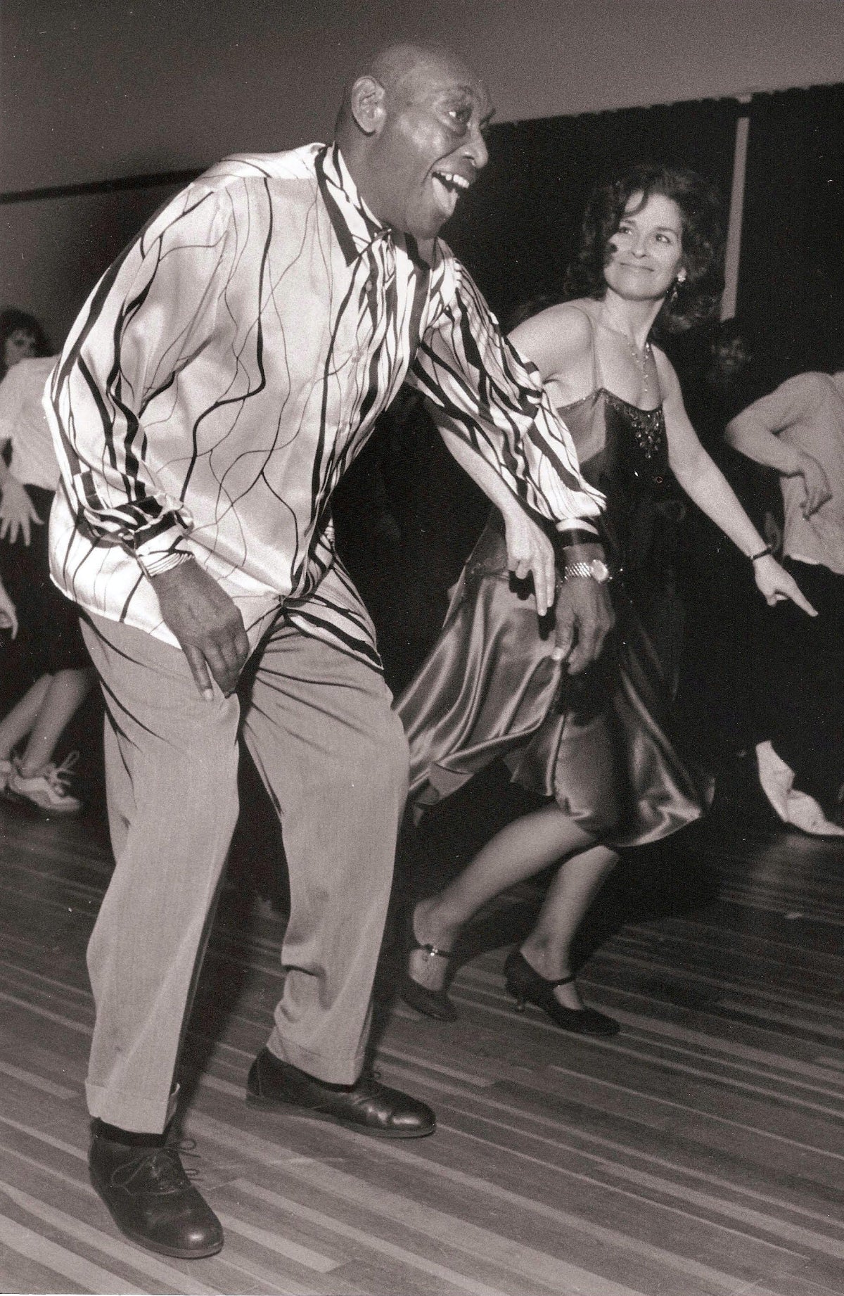 Frankie Manning dancing with Denise Steele on a crowded social dance floor